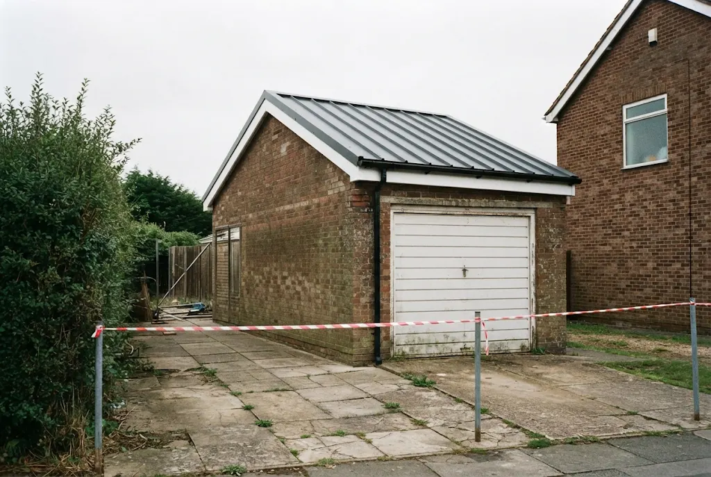 The same garage with a new roof fitted and the site cordoned